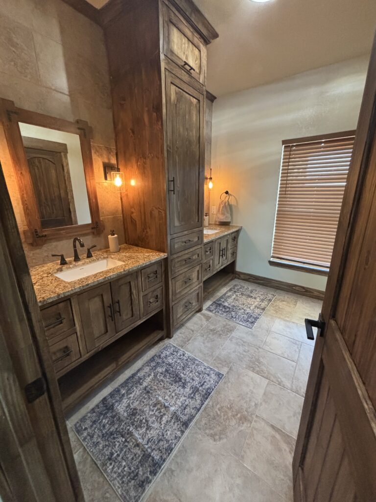 Cozy rustic bathroom with wooden cabinetry and warm lighting.